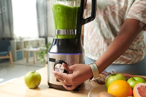 Preview: Girl turning on blender to make smoothie