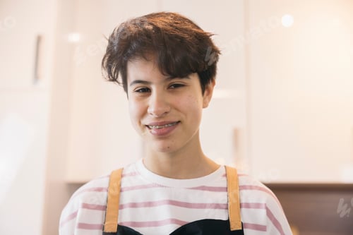 Preview: Portrait of a young girl smiling chef wearing apron and braces
