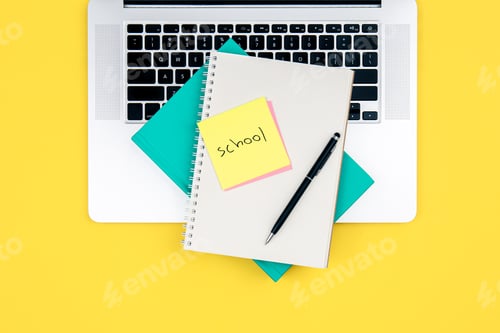 Preview: Laptop and notepad on a yellow background, top view.