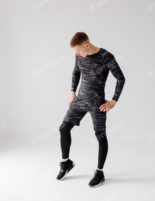 Preview: Athletic young man doing workouts at home, man doing training, warm up before weight exercise.