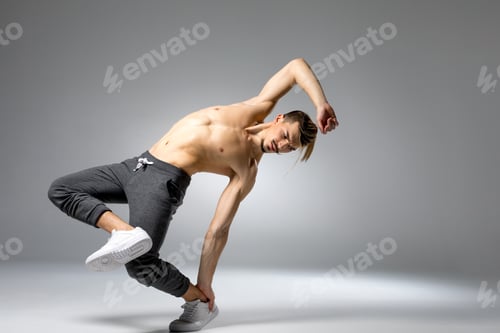 Preview: Young handsome shirtless man performing dance movement