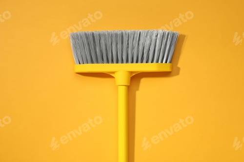 Preview: Plastic broom on yellow background, top view