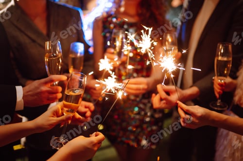 Preview: Glowing sparkles in hands. Group of happy people enjoying party with fireworks. Winter holiday.