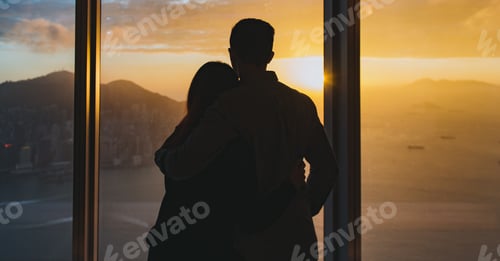Preview: Loving Couple Silhouetted Against a Beautiful Sunset Cityscape