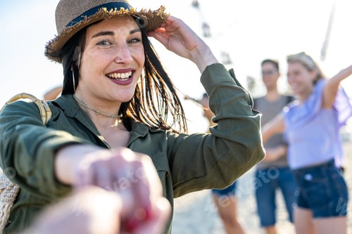 Preview: Young brunette woman with blue eyes inviting you to dance in a beach party