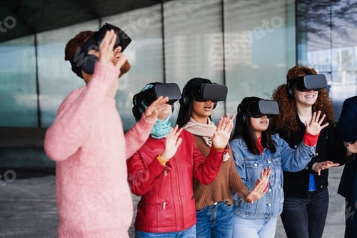 Preview: Young people wearing virtual headsets outdoor - Focus girl face wearing denim jacket