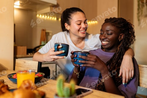 Preview: Lesbian couple enjoying morning coffee and breakfast at home
