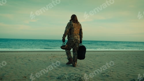Preview: Soldier walks down beach toward ocean ready for rescue by dinghy