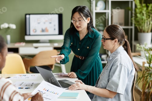 Preview: Colleagues discussing online presentation at office