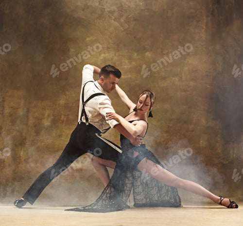 Preview: Flexible young modern dance couple posing in studio.
