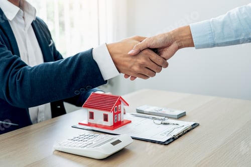Preview: Estate agent and customers shake hands together celebrating the