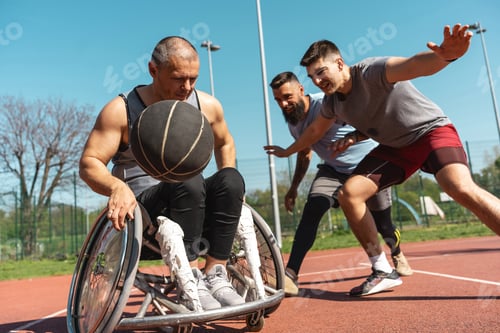 Preview: A physically challenged person play street basketball with his friends.