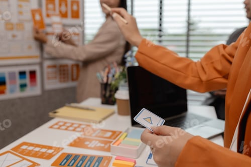 Preview: ux developer and ui designer brainstorming about mobile app interface wireframe design in the office