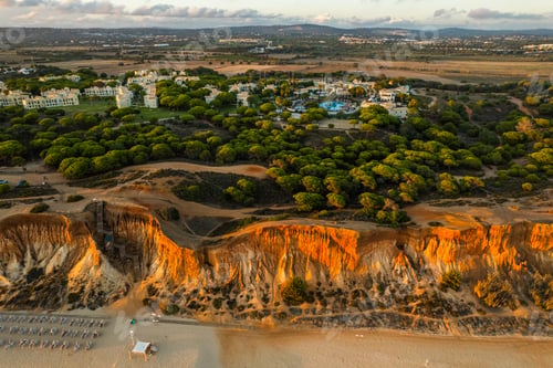 Preview: Praia da Falesia, Algarve beach in Albufeira, Portugal. Aerial drone view at sunset