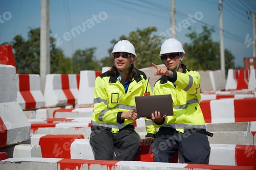 Preview: Two surveyor of construction engineer, architect, in hardhat working on construction site.