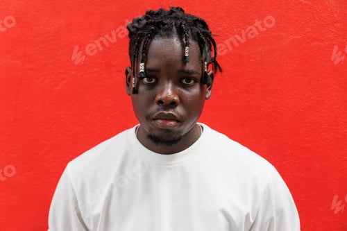 Preview: African American man looking at camera. Isolated on red background