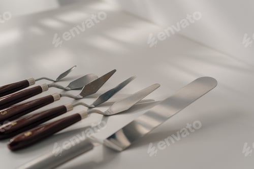 Preview: different types of pastry spatulas cooking utensils for cakes on table on white background close-up
