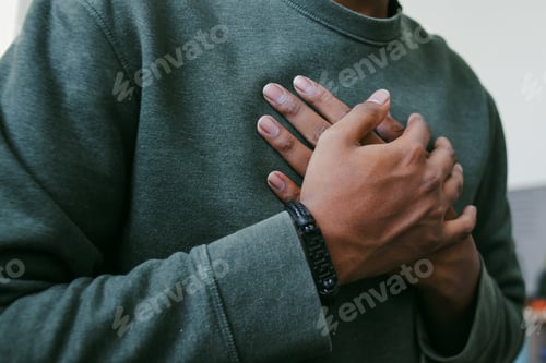 Preview: Selective Focus of Hands on Chest Praying Together With His Friend Against Blurry Background