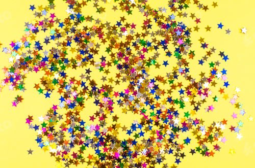 Preview: Shining colorful stars on yellow background.