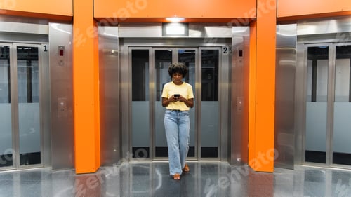 Preview: Young woman using mobile phone at subway station