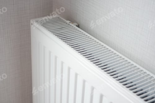 Preview: White radiator on grey white wall. apartment heating installation system,