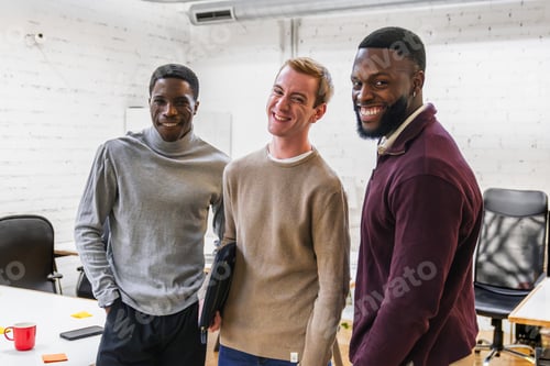 Preview: Young professionals smiling together in coworking space