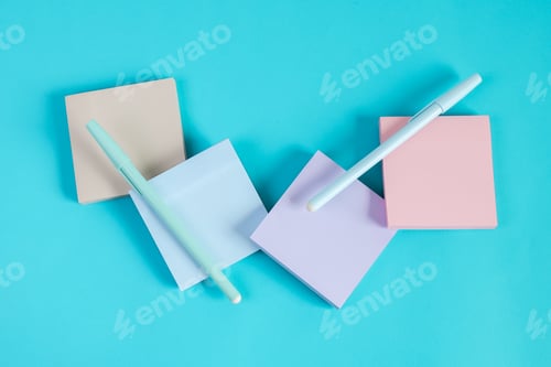 Preview: Vibrant Pastel Sticky Notes And Pens Arranged Isolated On Blue Background