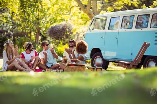 Preview: Group of friends having fun together near campervan