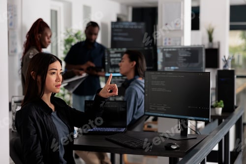 Preview: Concentrated web developer working with hologram and coding language