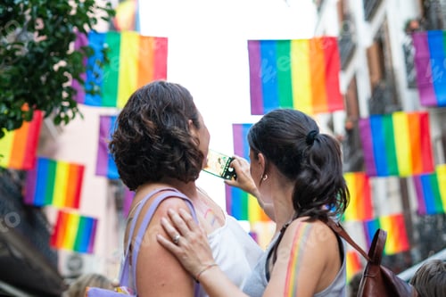 Preview: Women taking photos at gay pride parade celebrating lgbtq+ rights