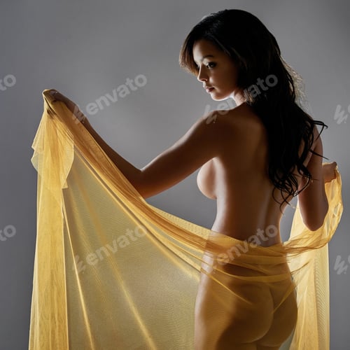 Preview: Rearview shot of a sexy young woman posing nude with a sarong against a grey background
