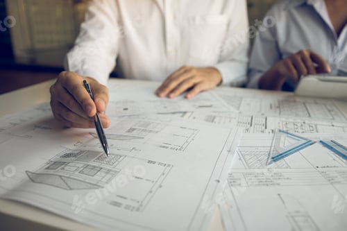 Preview: Architects engineer working with blueprints on table and discussing project together