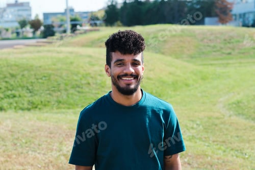 Preview: Happy hispanic man smiling outdoors in park