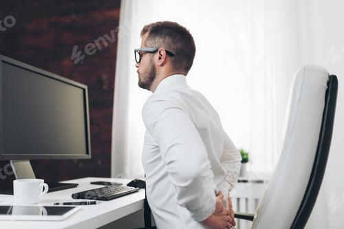 Preview: Office worker with pain from sitting at desk all day