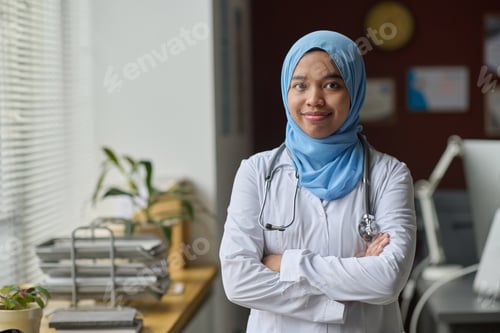 Preview: Smiling Woman Doctor in White Coat in Office