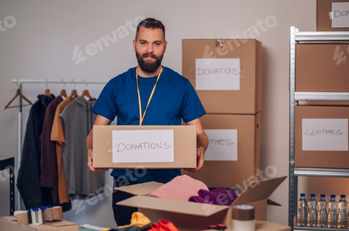 Preview: Portrait of a man volunteer working in a charity donation center