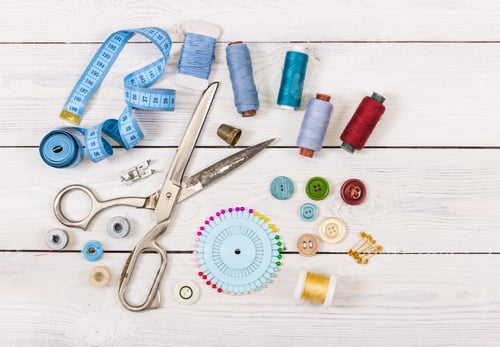 Preview: Tools and accessories for sewing on light wooden background.