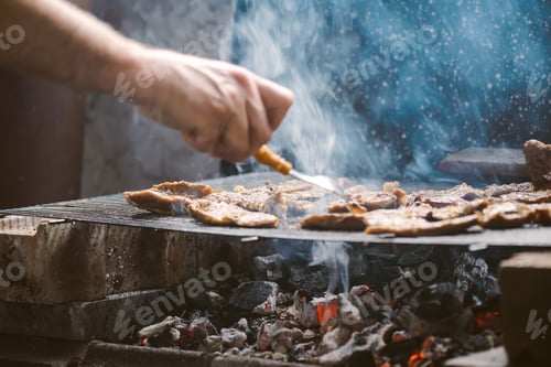 Preview: Grilling pork meat chops on barbecue