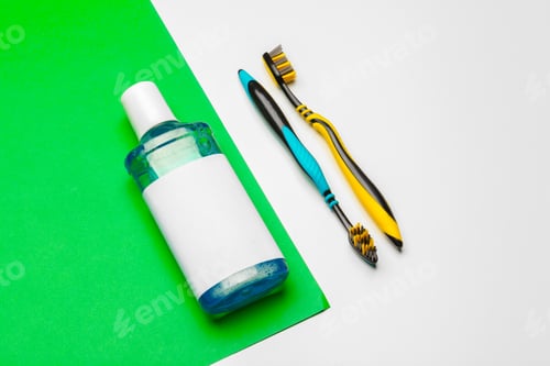 Preview: Flat lay composition with manual toothbrushes and oral hygiene product