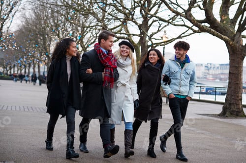 Preview: Friends Walking Along South Bank On Winter Visit To London