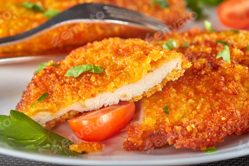 Preview: Fresh breaded chicken schnitzel with cherry tomatoes and herbs
