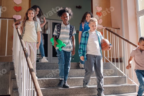 Preview: Group of elementary school students walking down the stairs after school