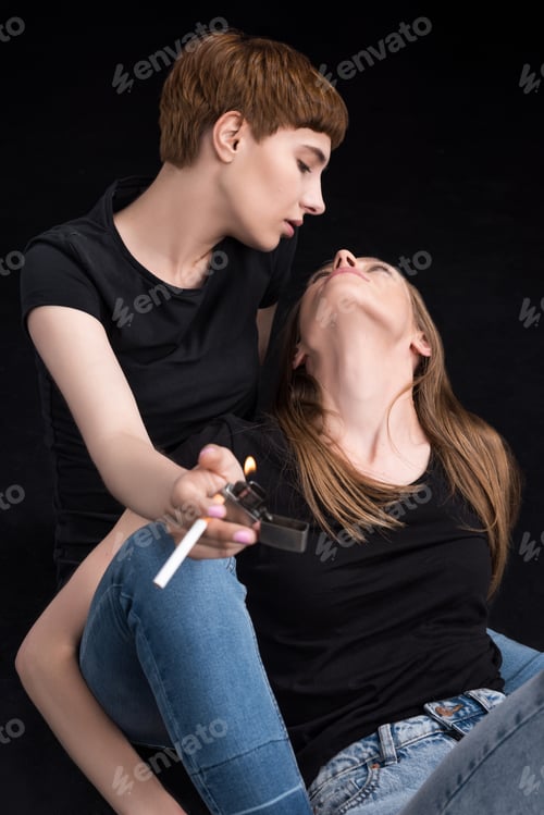 Preview: Half-length shot of young lesbian couple embracing and looking at each other