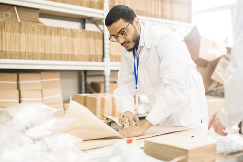 Preview: Factory Worker Wrapping Manometer in Paper
