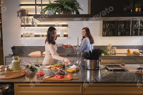 Preview: Female friends bonding while cooking together