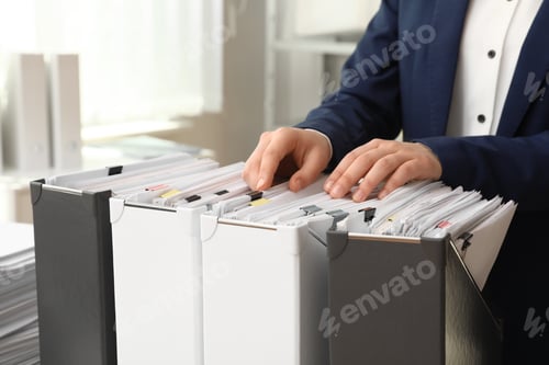 Preview: Woman taking documents from folder in archive, closeup