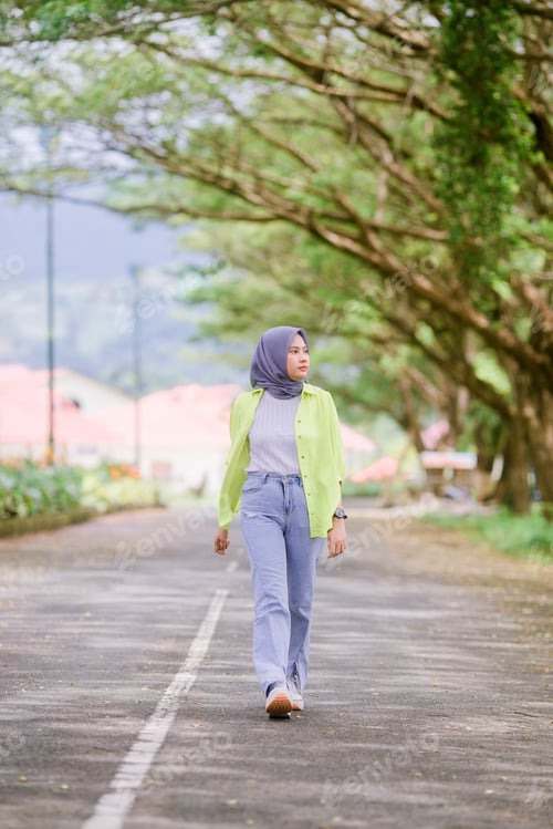 Preview: Woman Strolling Down a Tree Lined Road