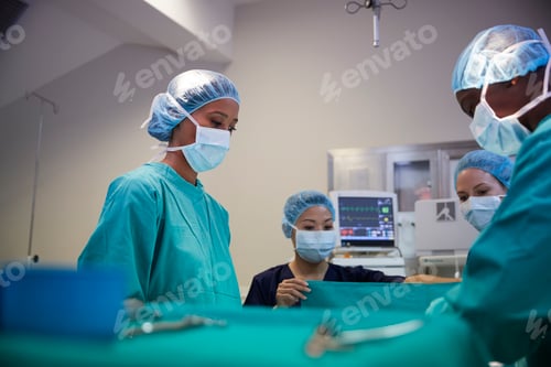 Preview: Surgical Team Working On Patient In Hospital Operating Theatre