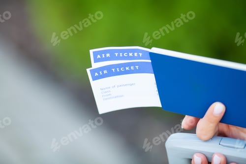 Preview: Travel. Woman holding two air ticket in abroad passport near airport