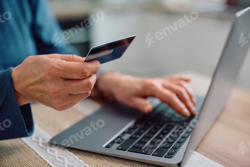 Preview: Close up of senior woman paying online with her credit card.